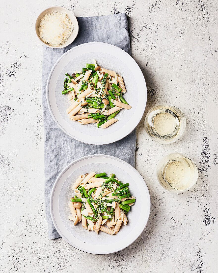 Two bowls of asparagus and mushroom pasta