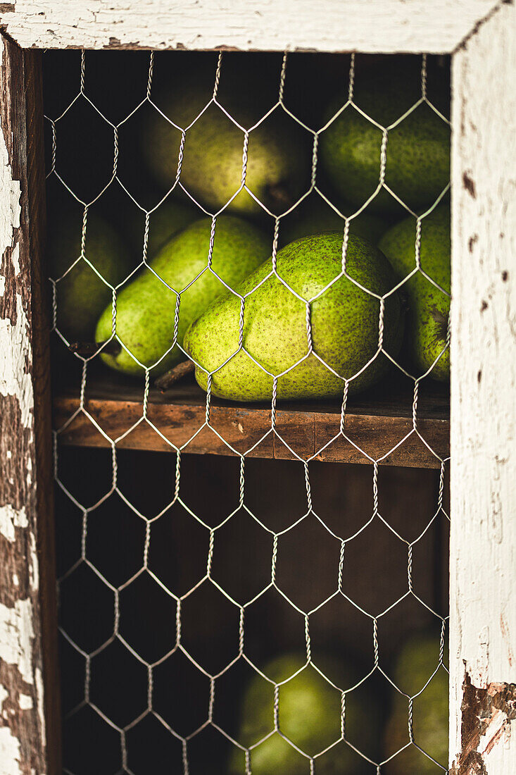 Pears ripening in a rustic kitchen cupboard