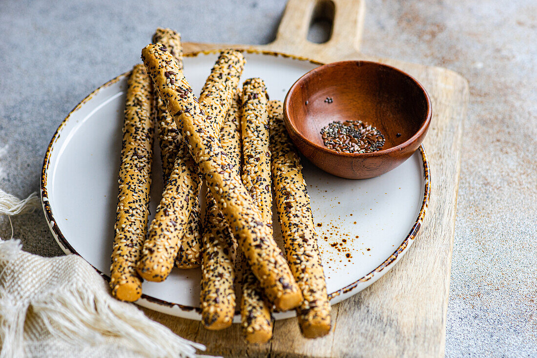 Fresh baked bread sticks with seed mix on the plate