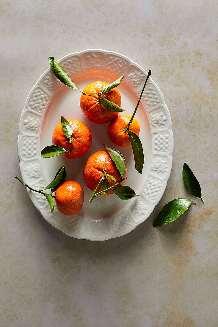 Stem & Leaf mandarin oranges on a white plate