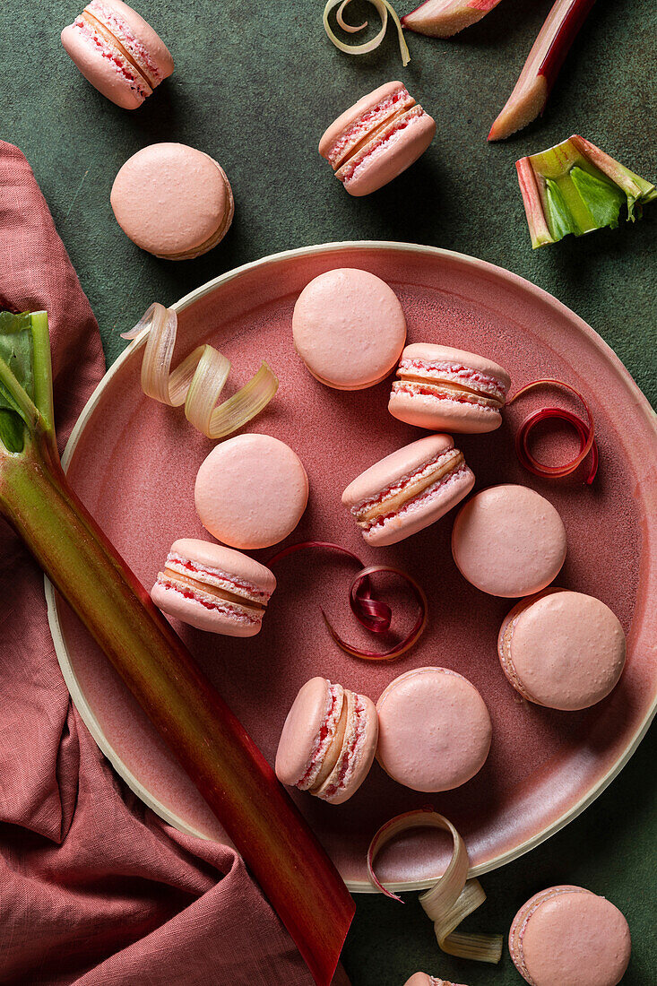 Rhubarb macarons on a green background