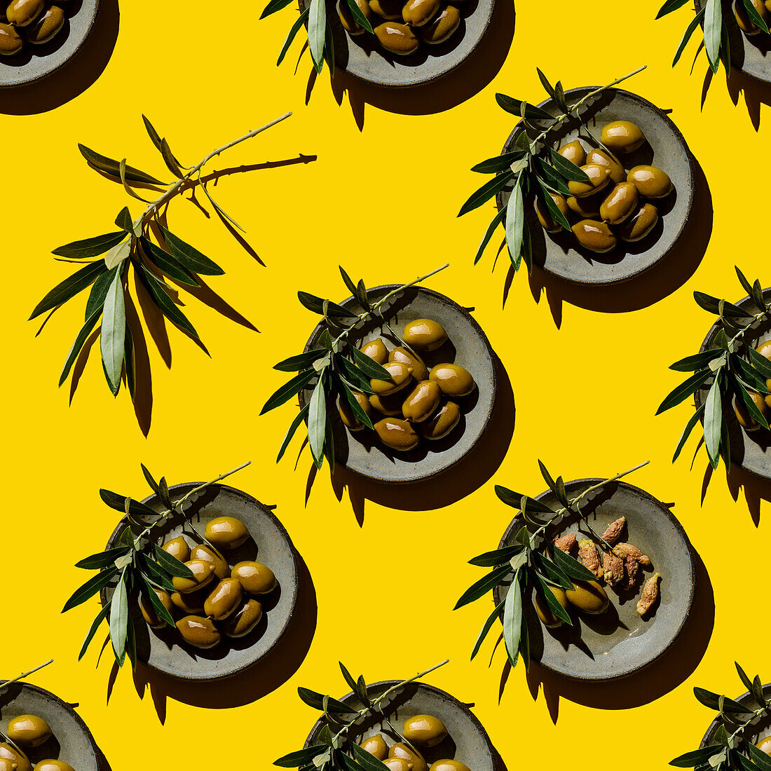 Green olives on a plate on a yellow background pattern