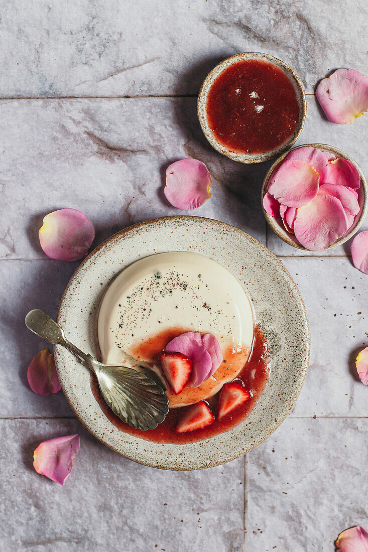 Flat rose panna cotta with strawberry compote and spoon