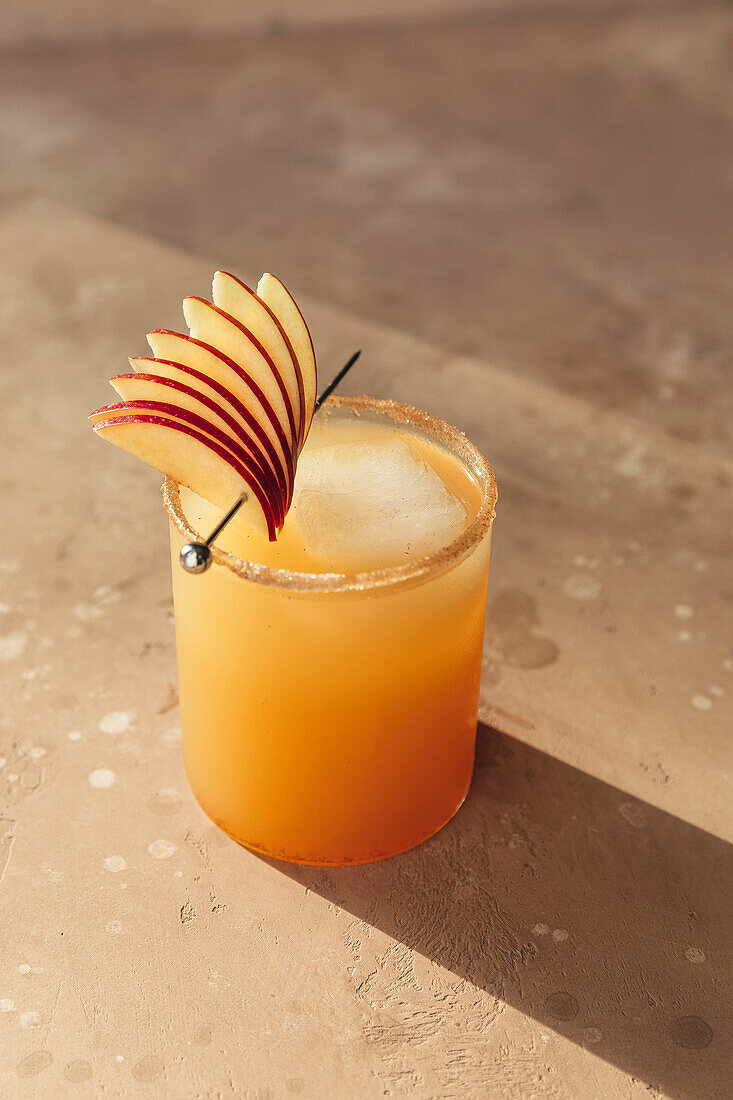 Spiced apple drink garnished with sliced apple