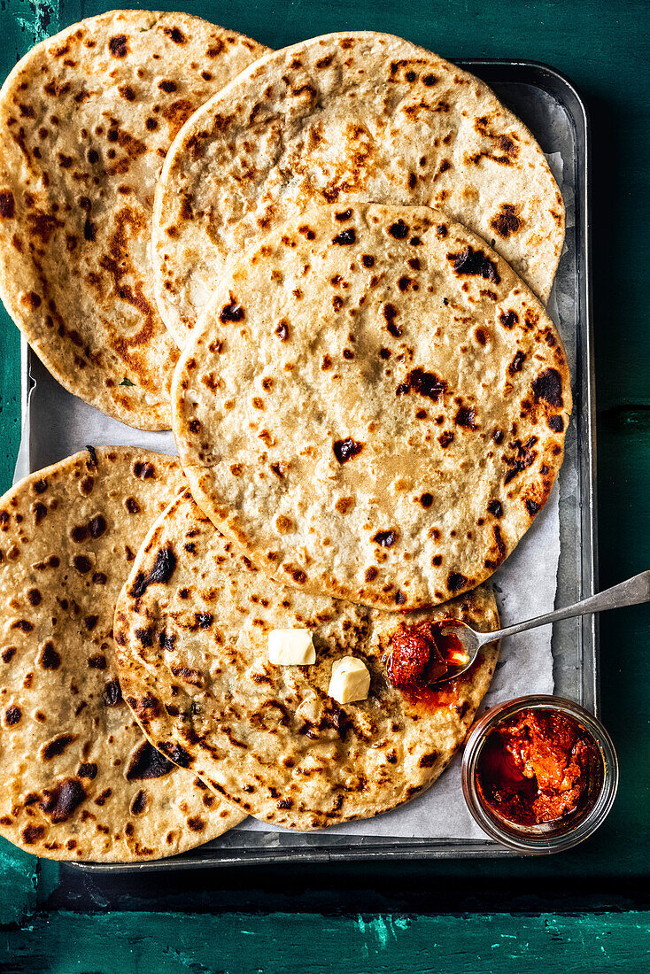 Flat plate of stuffed aloo paratha Indian potato flatbread