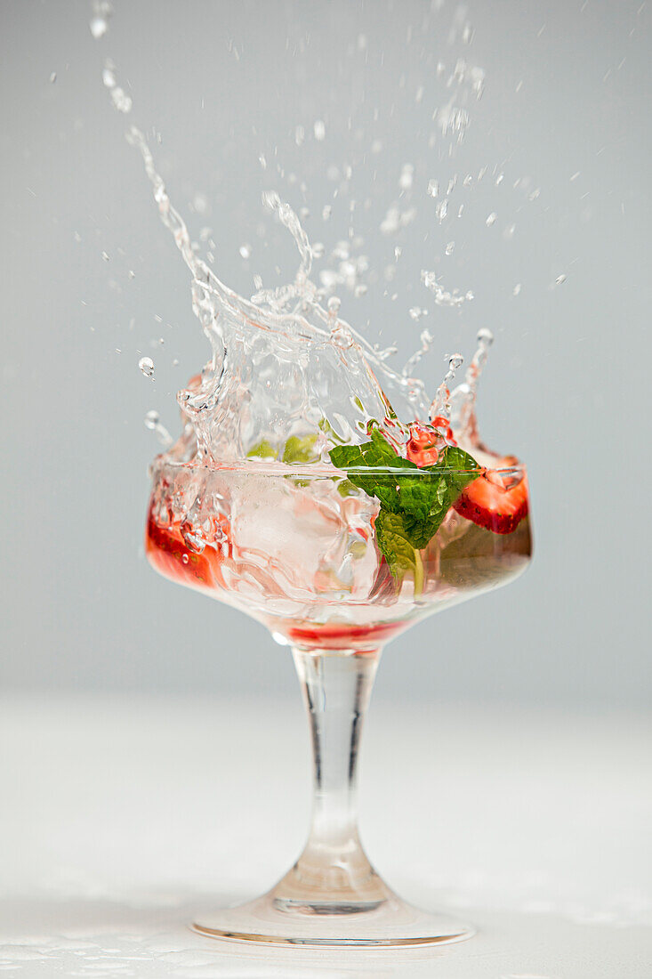 A splash in a cocktail glass with blanks
