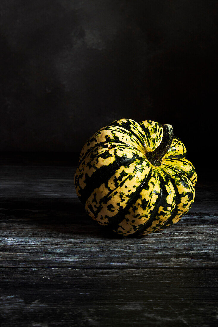 Pumpkin portrait on a dark surface and background