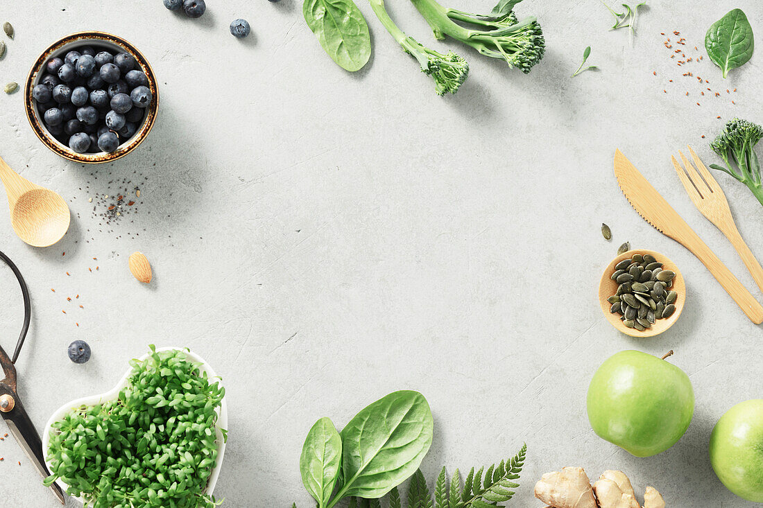 Vegetarian vegan healthy ingredients and green smoothie on a grey stone background. Healthy eating, eco-friendly, zero waste concept banner