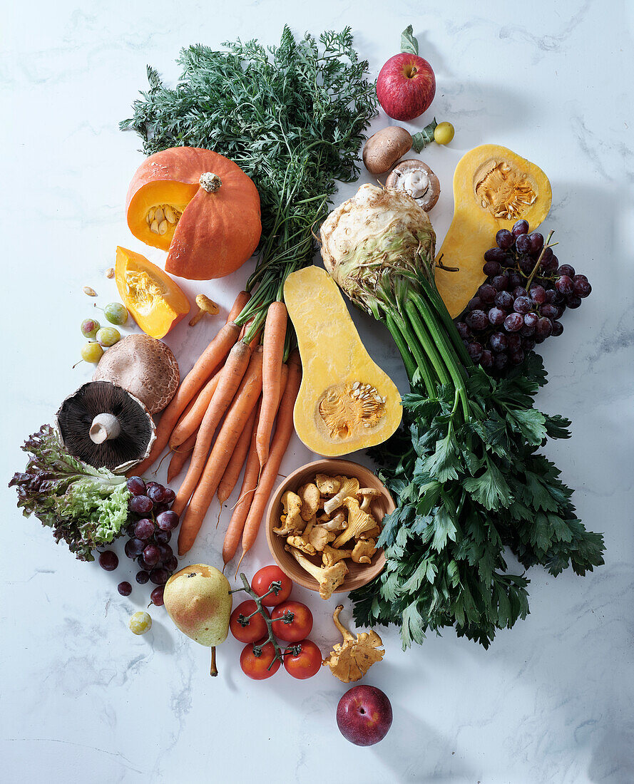 Healthy seasonal vegetarian food. Flat dish with autumn vegetables, fruit and mushrooms from the local market. Vegan ingredients