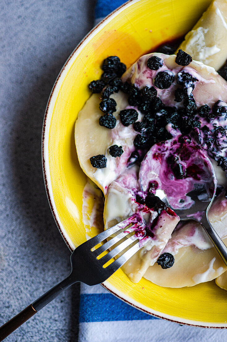 Delicious traditional Ukrainian dumplings with blueberries and sour cream