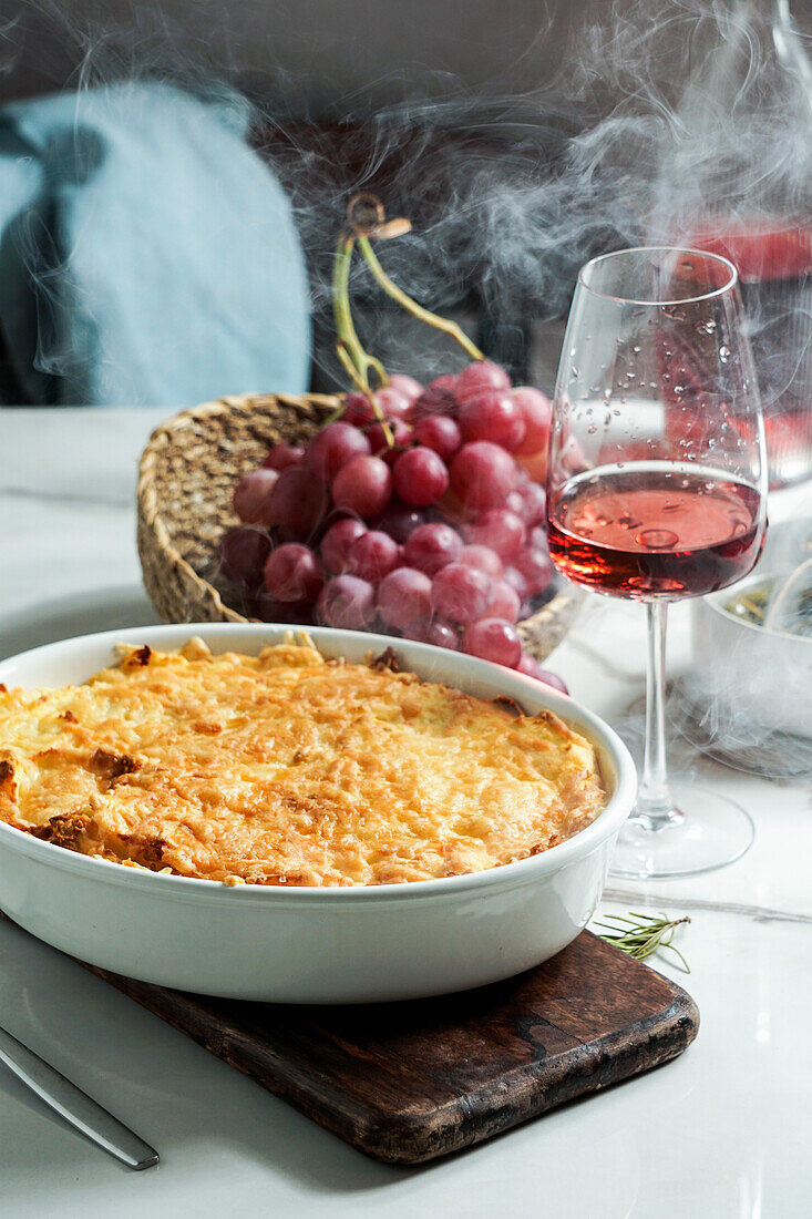 Shepherd's pie or cottage pie is a casserole with a layer of cooked meat and vegetables, topped with mashed potatoes