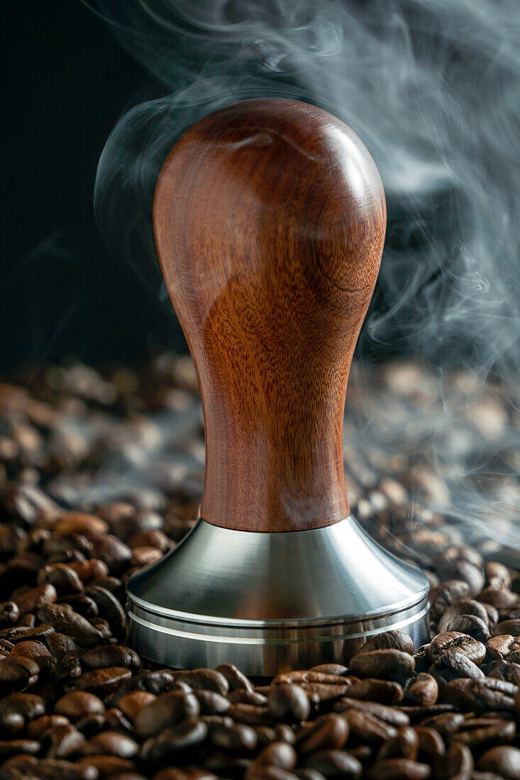 Coffee steamer with steam and coffee beans