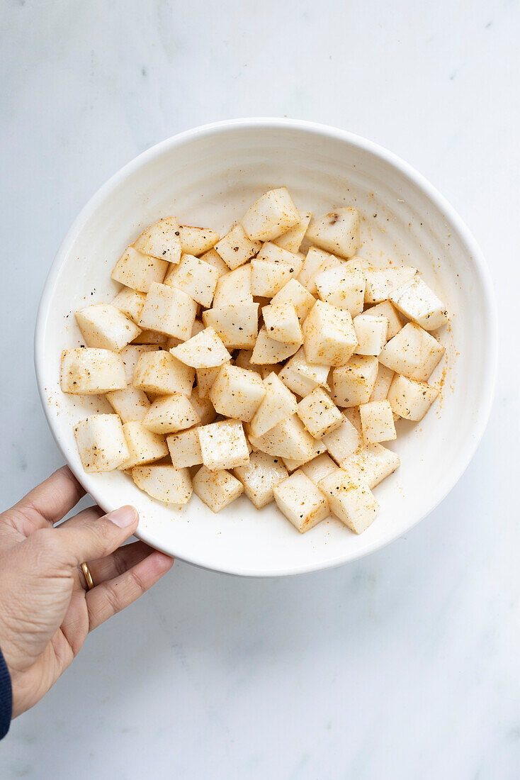 Turnip cubes in a white bowl