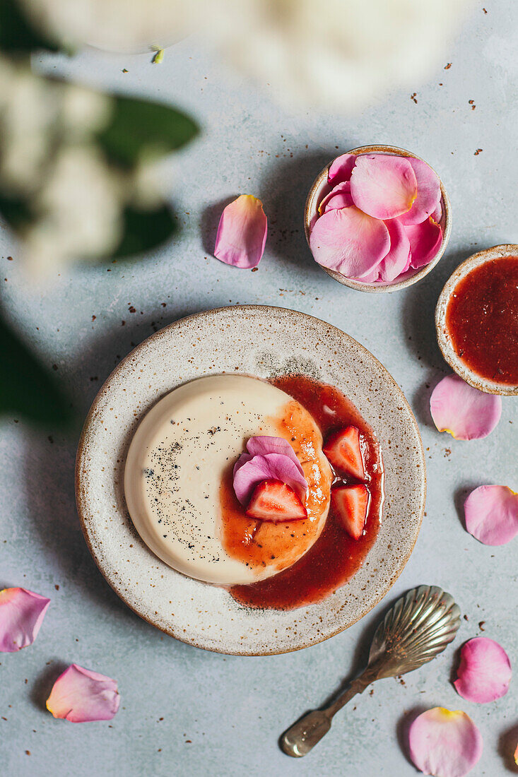 Rose panna cotta with strawberry compote on a plate