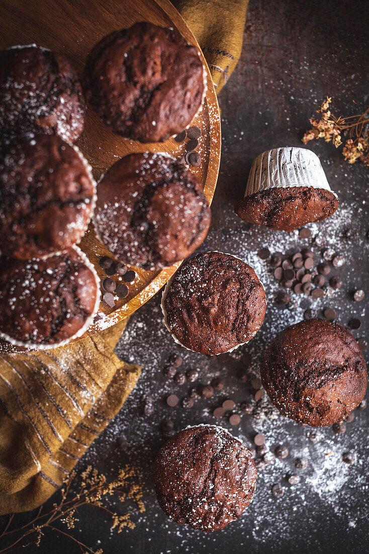 Homemade chocolate muffins with cholcolate crisps in a rustic kitchen