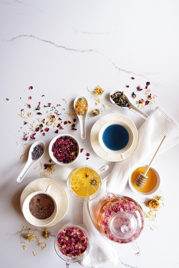 Selection of herbal teas, rose petal, calendula, lavender, and blue butterfly pea flower, known for their flavor, medicinal and nutritional properties. Negative copy space.