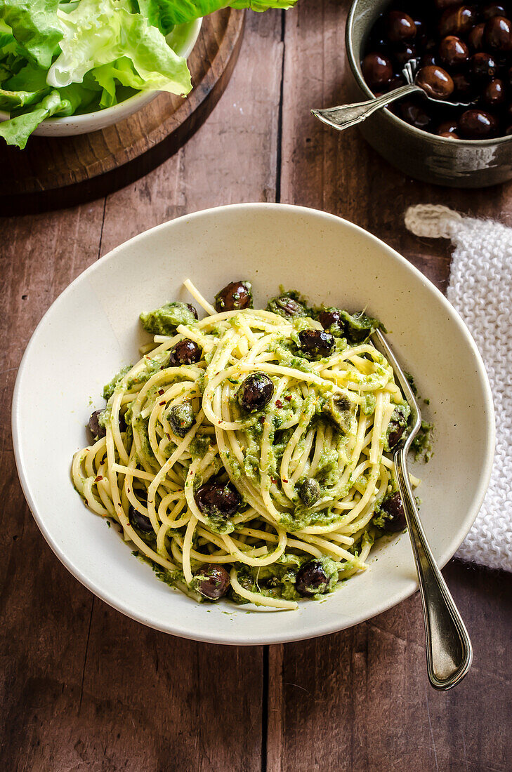 Spaghetti with escarole pesto and black olives