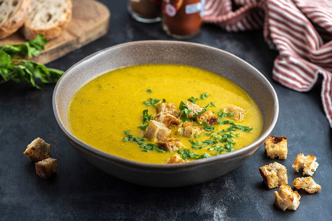 Cream of courgette soup. The dish is served with diced crutons. View from above