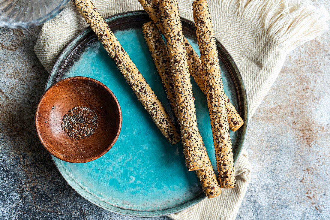 Freshly baked breadsticks with seed mix on the plate