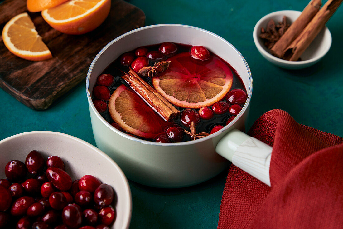 Mulled wine preparation with orange cranberries and cinnamon