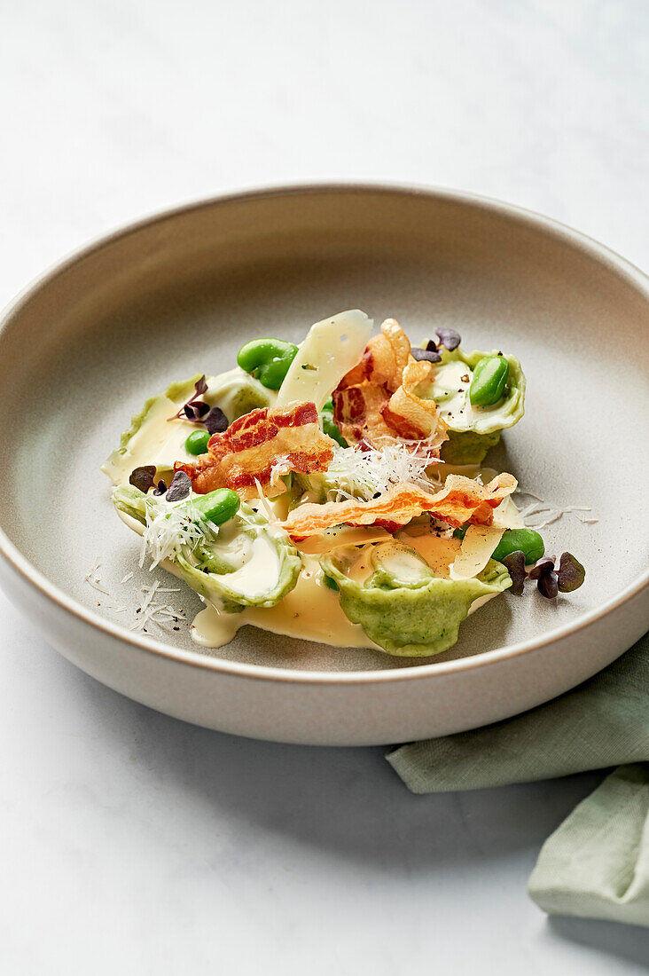 Tortelloni, cream sauce, pancetta, broad beans, pecorino, basil