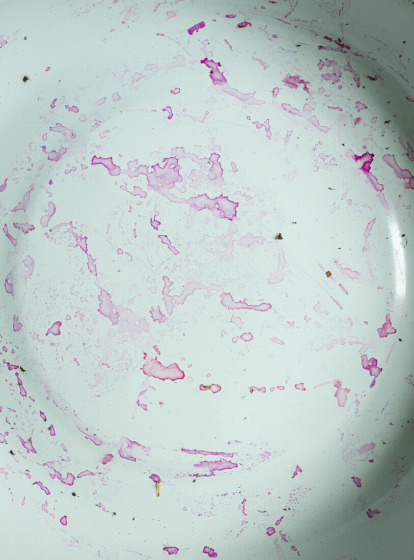 White enamel plate with beetroot juice stain in close-up