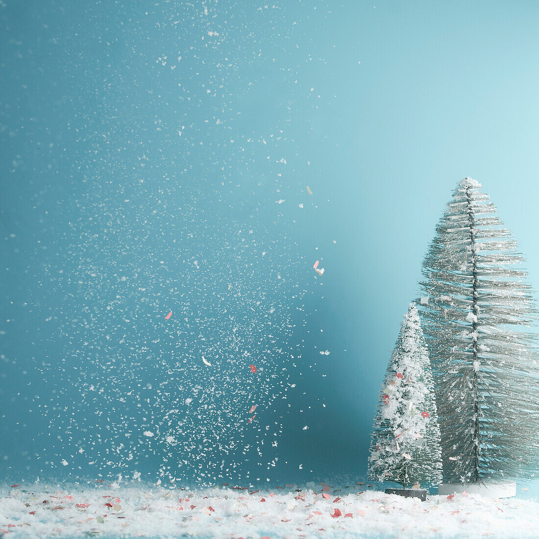 Winter, Christmas or New Year background with fir trees and falling snow at blue
