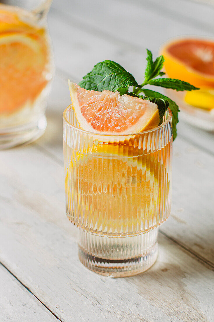 Drink with grapefruit, orange and lemon, garnished with mint