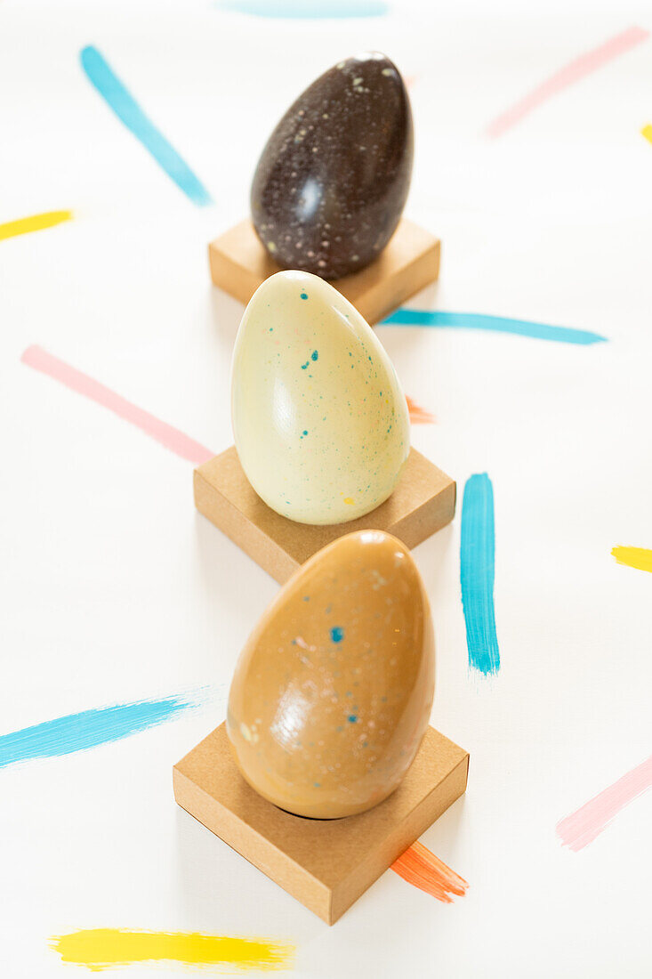 A creative arrangement of decorated Easter eggs on a white background with colorful strokes