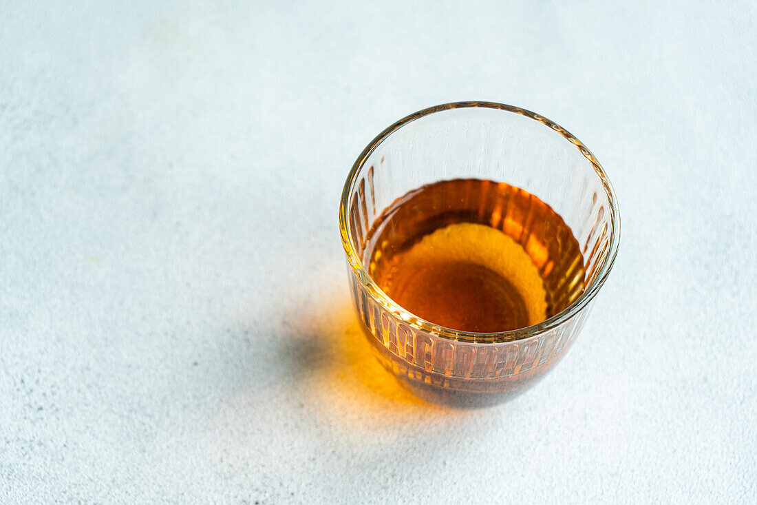 From above glass of Georgian variety of wine Kisi on white concrete table