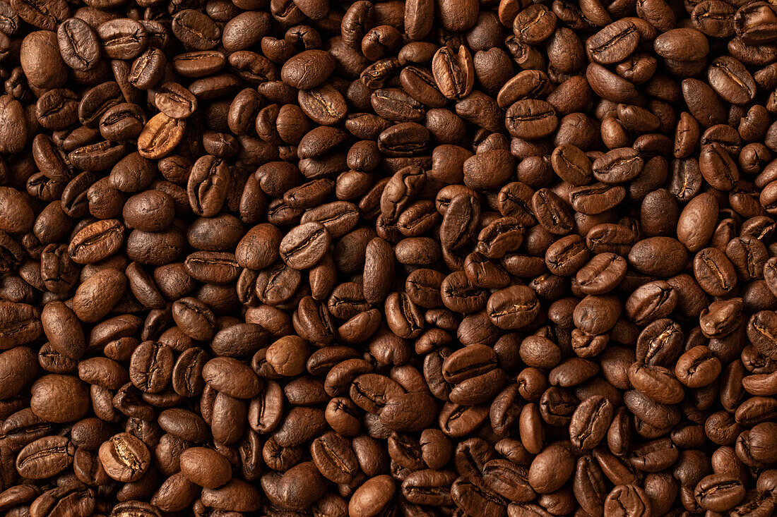 Top view of backdrop representing halves of dark brown coffee beans with pleasant scent