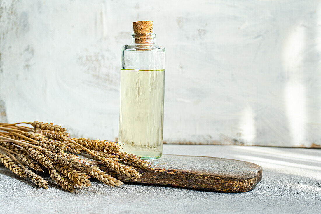 Traditional Ukrainian alcoholic drink made from wheat and known as Gorilka served in transparent bottle placed on cutting board against blurred background