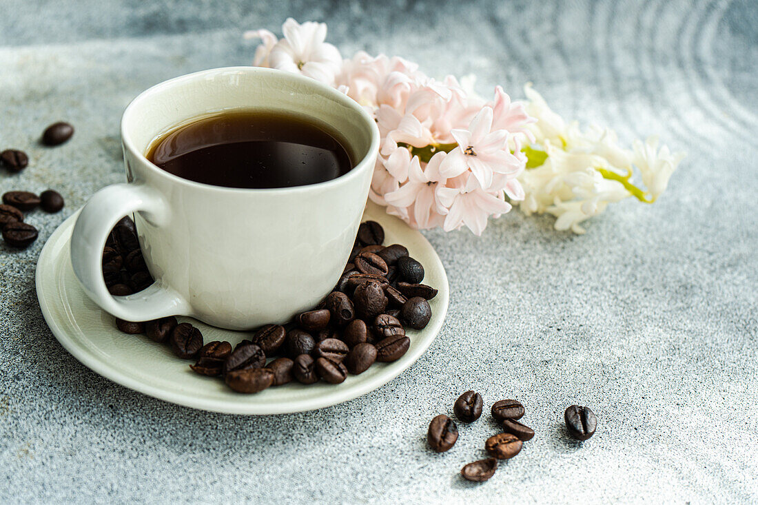 Cup of black coffee served on concrete table in the sunny morning