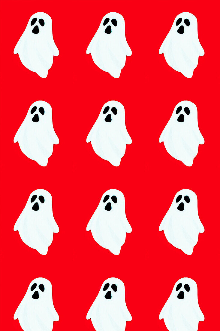 Seamless vector illustration of smiling cartoon ghosts placed in parallel rows against vivid red backdrop