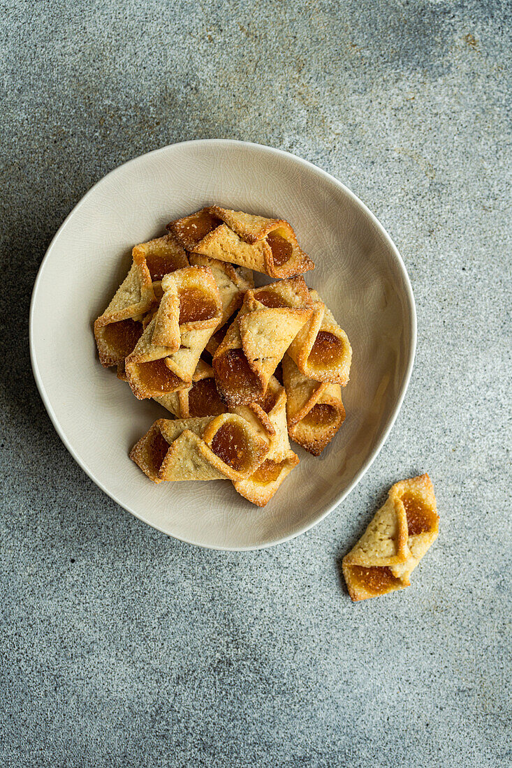 Homemade fresh baked pastry with lemon jam on grey concrete table