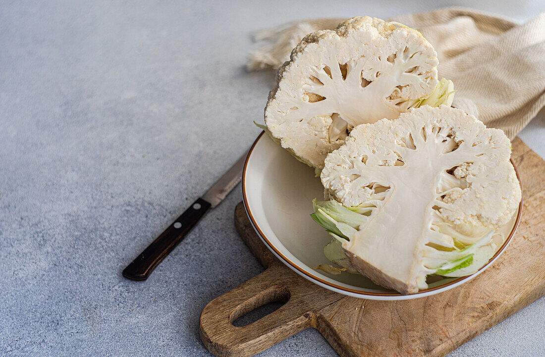 Raw cauliflower vegetable ready for cooking on concrete table