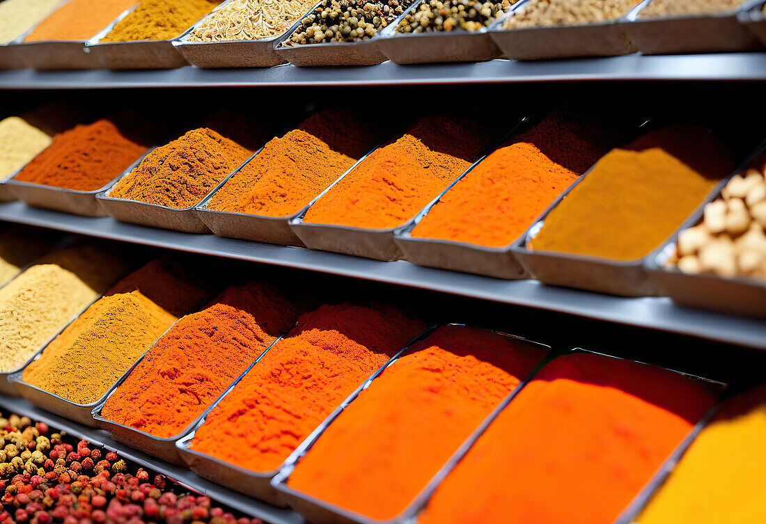 Closeup of piles of colorful spices placed in array on stall in local market in Morocco