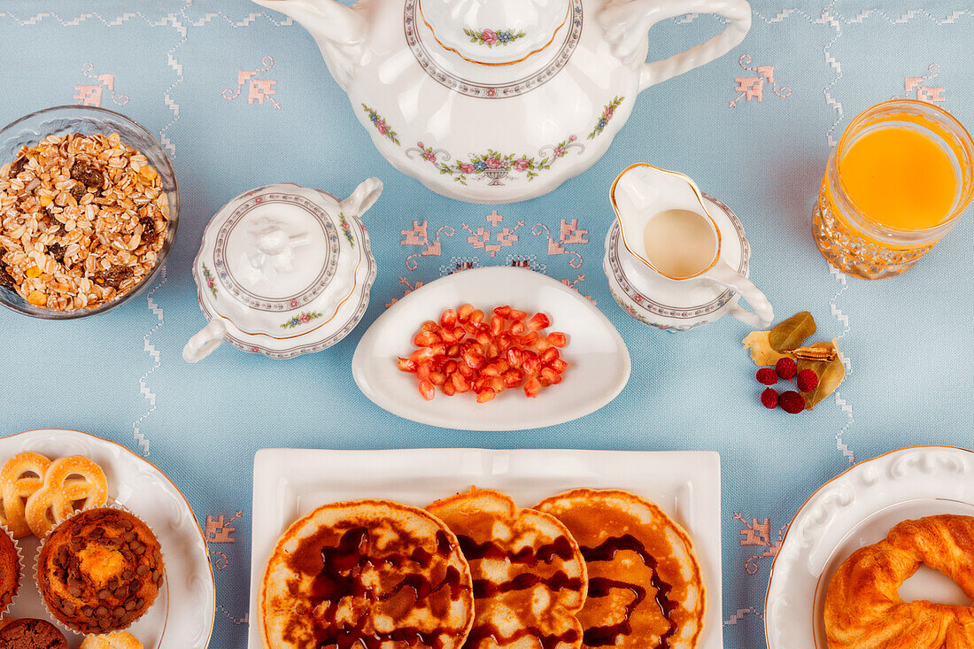 An inviting breakfast setup featuring waffles with toppings and a variety of morning treats.