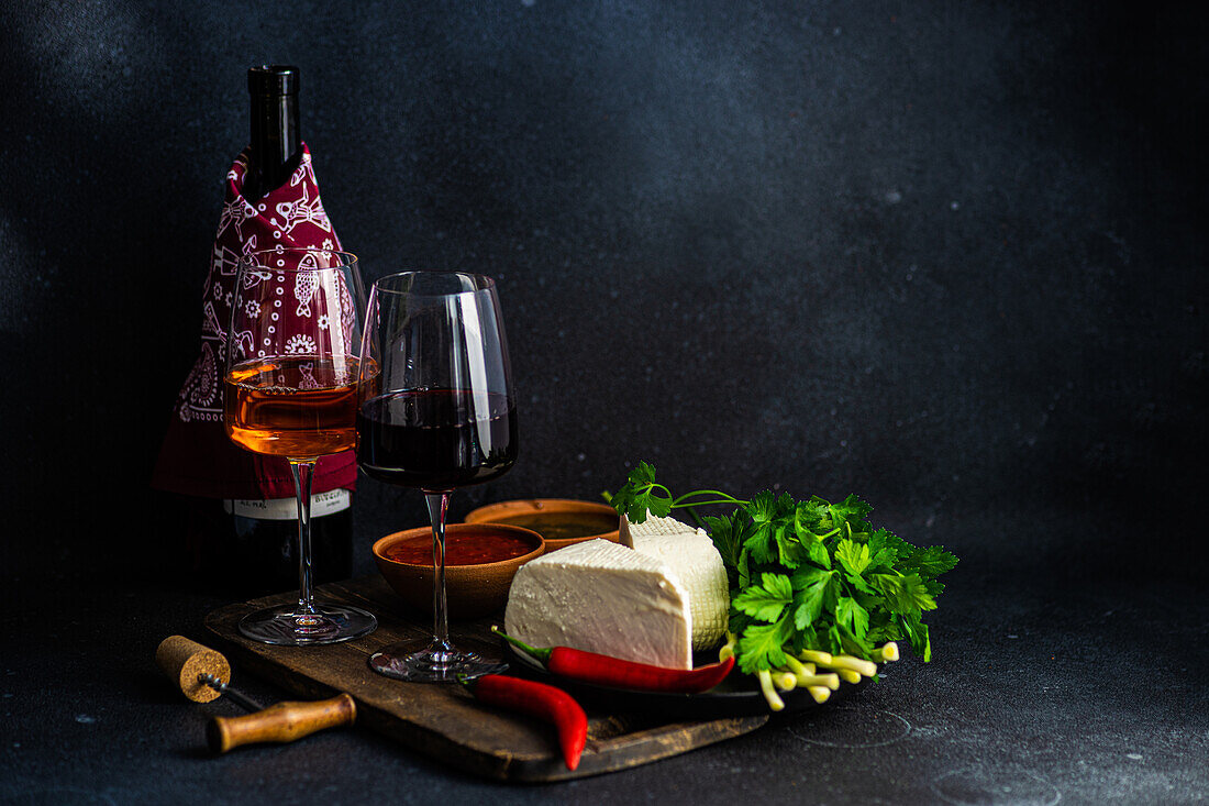 Traditional Georgian food concept with spices, sauces and wines on dark concrete table