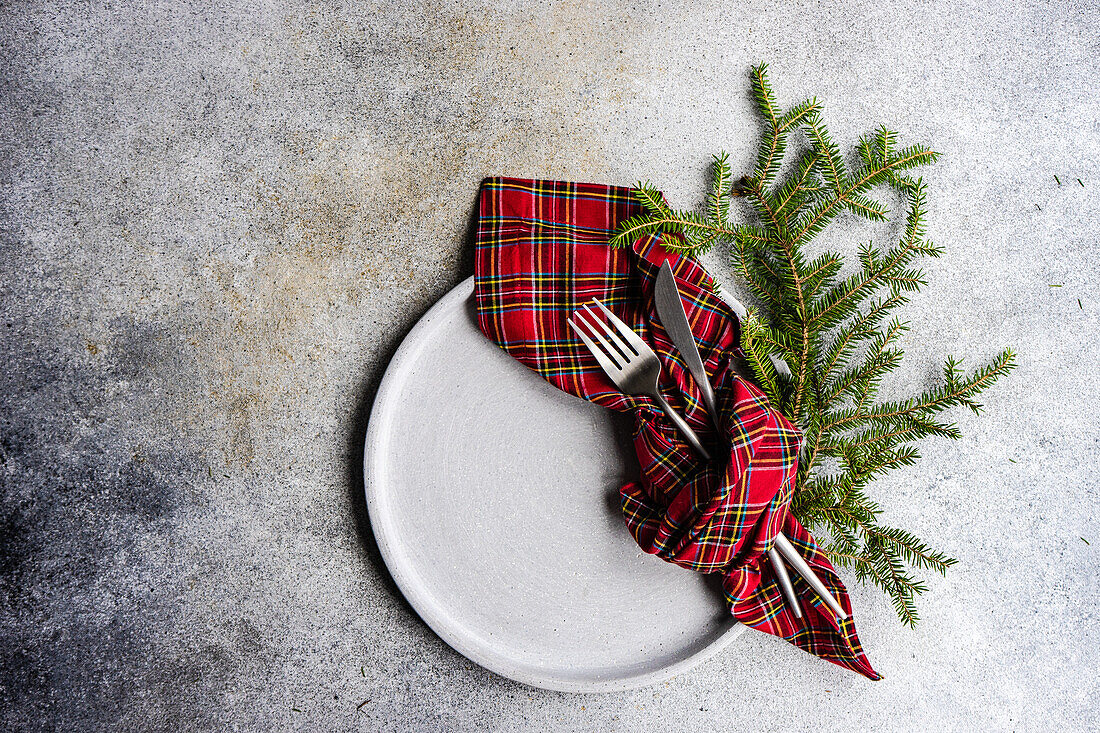 Place setting for Christmas or New Year Eve festive dinner on stone background