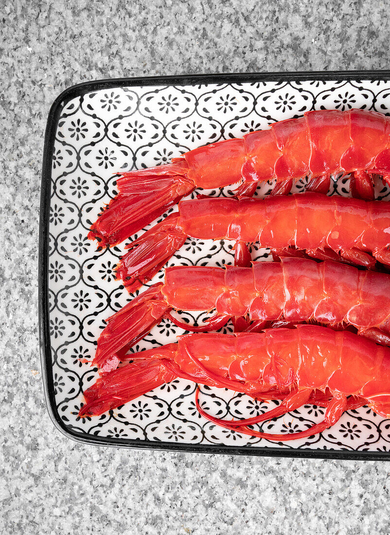 Closeup top view of fresh raw shrimps crayfish placed on tray over grey marble table