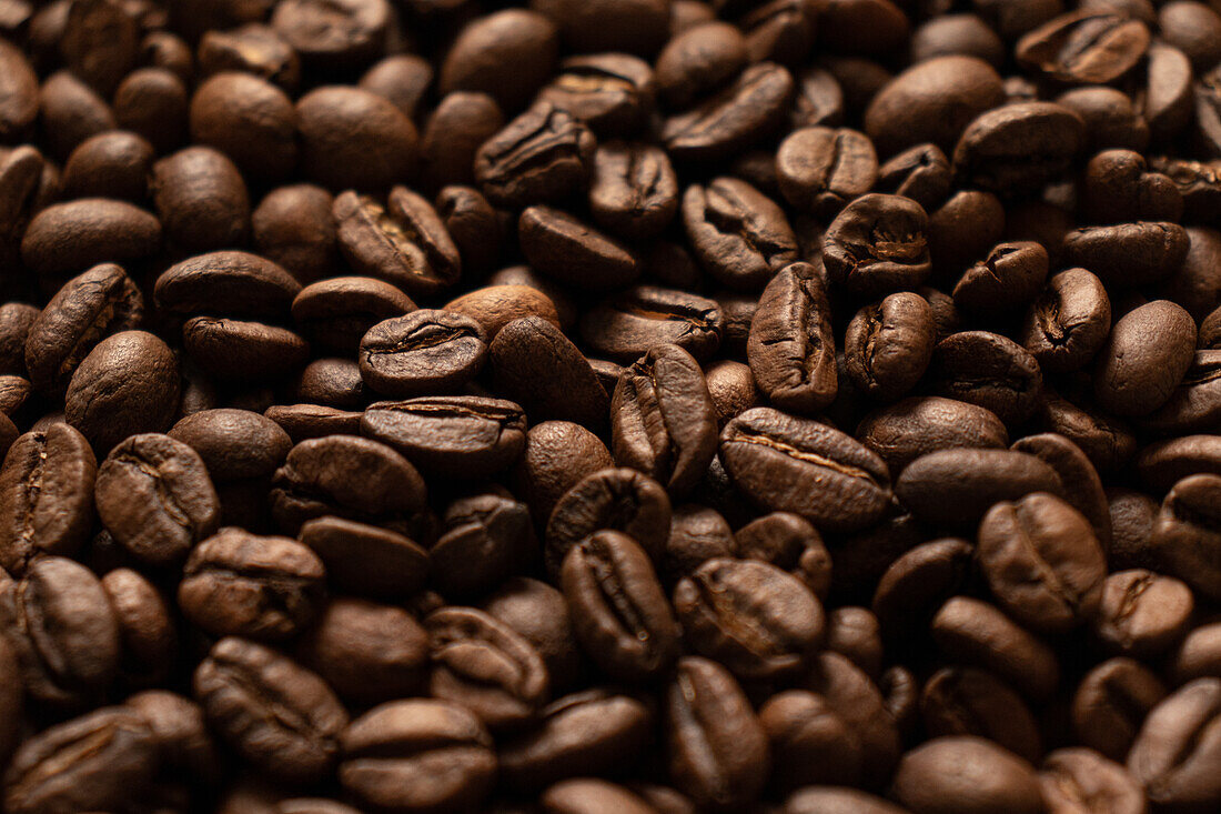 Textured background of freshly roasted coffee beans