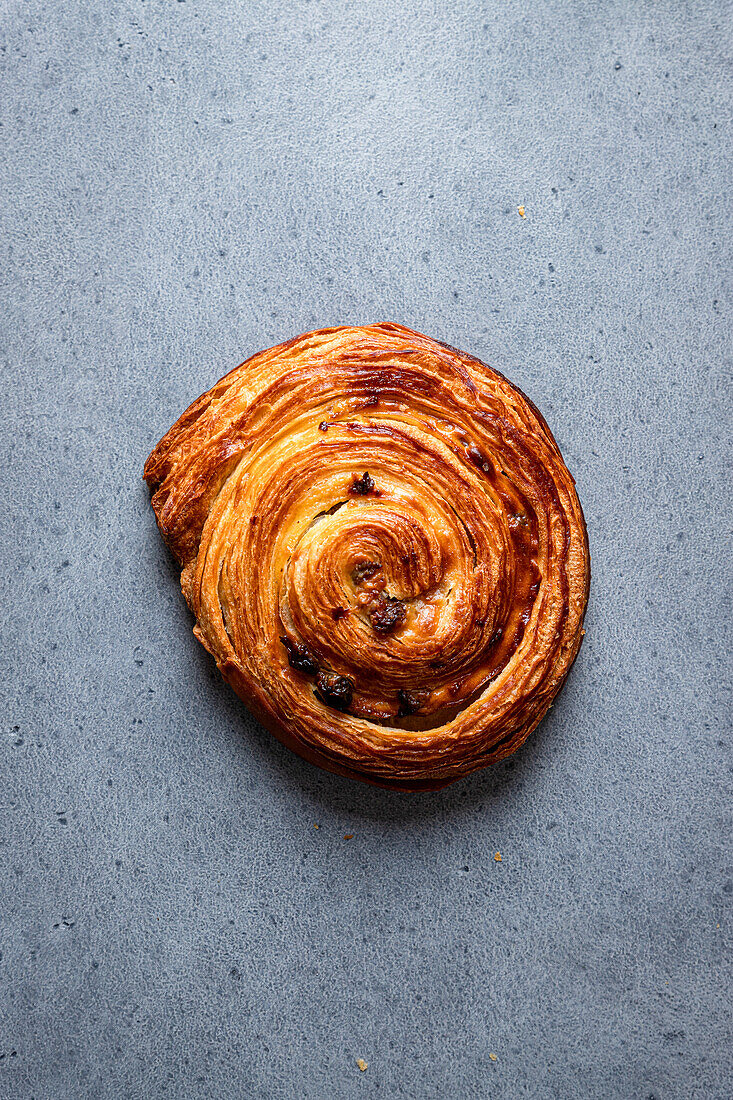 Top view of snail pastry placed on grey board