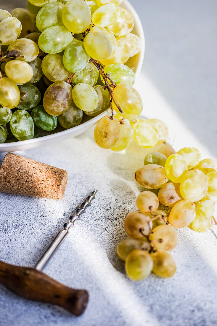 Georgian Mtsvane wine in glass and fresh raw grape on rustic table