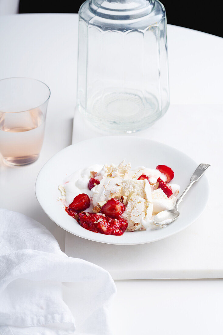 Dessert with berries, meringue and whipped cream. Eton's mess with strawberries, sweet treat with summer mood