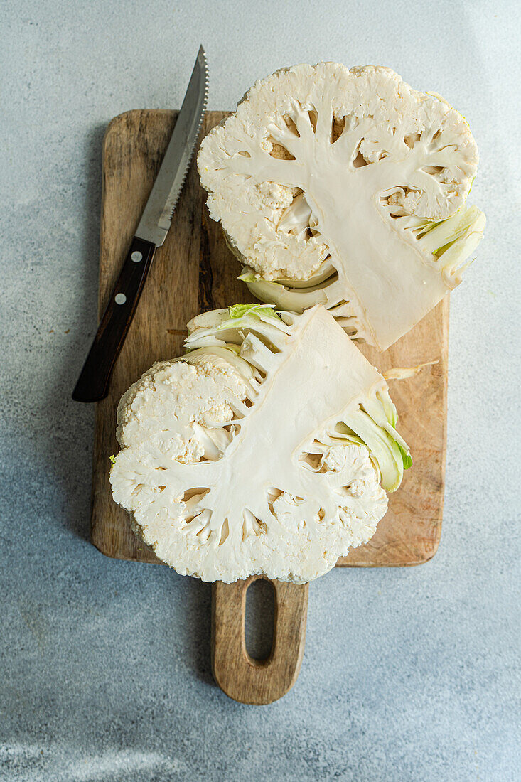 Raw cauliflower vegetable ready for cooking on concrete table