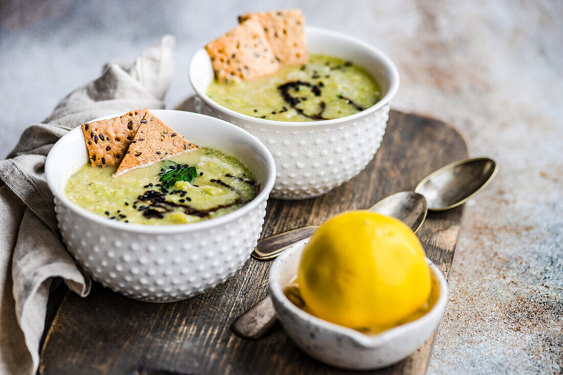 From above healthy zucchini soup in the bowl with crackers