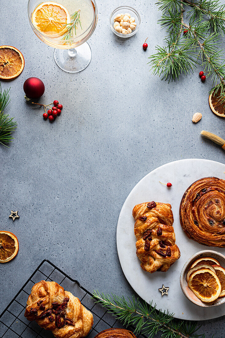 Top view of delicious homemade baked assorted pastries placed on plate with Christmas decoration around