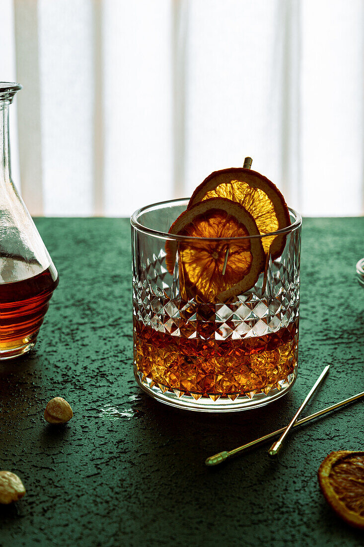 Composition of cold icy liquor garnished with orange slice and placed on table