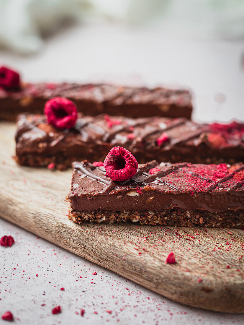 Nahaufnahme von mehreren Schokoladentafeln mit Himbeeren auf einem Tisch